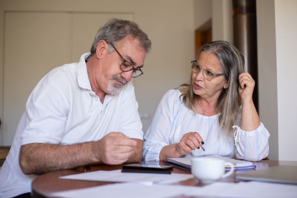 A couple working through their retirement finances at home