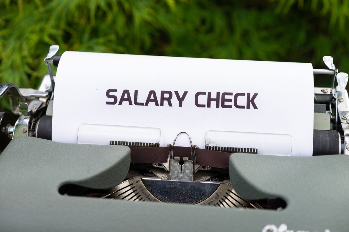 A typewriter typing the words salary check