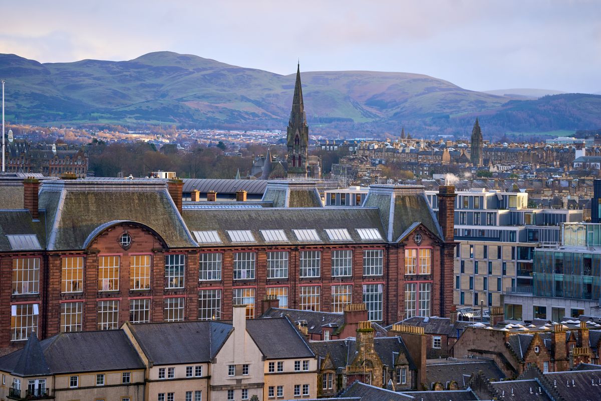 Edinburgh skyline at dusk with the Pentland Hills behind